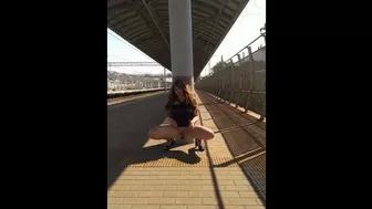 A beautiful, young exhibitionist girl in a transparent dress shows her pussy at the railway station.