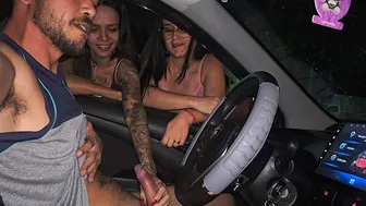 Two hot girls caught him masturbating inside the car and helped him cum.